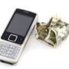 Cellphone next to a crumpled dollar bill.
