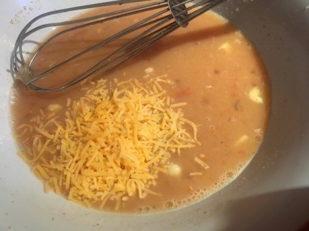 adding cheese to egg mixture