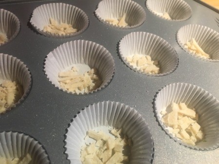 adding tortilla strips to

lined baking tins