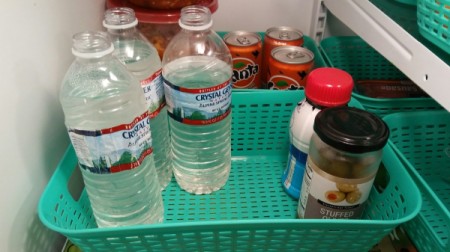 Refilled water bottles in the refrigerator.