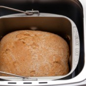 Closeup of cooked loaf of bread in a bread machine.