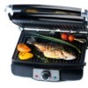 Electric tabletop grill with fish and veggies.