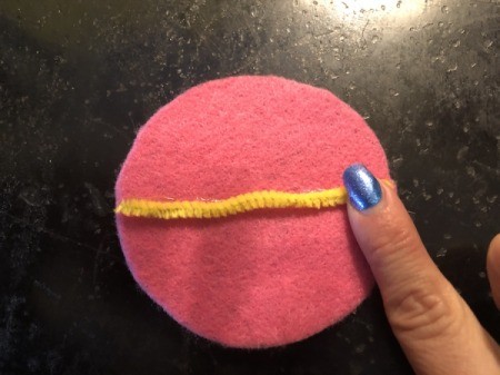 Felt Fortune Cookies - glue down the cut piece of pipe cleaner, repeat for all of your circles