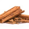 A pile of cinnamon sticks on a white background.