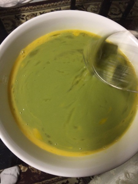 adding blended pandan leaves to eggs