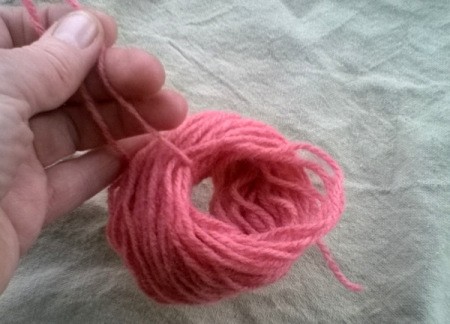 Making a Woolly Monster - thread a short length of wool througn the circle