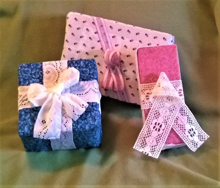 Fabric Covered Display Boxes - display packages wrapped in fabric and tied with lace bows