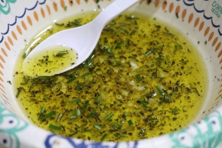mixing olive oil and herbs
