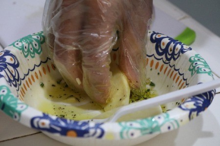 Dipping Sweet Potato piece in seasoned olive oil