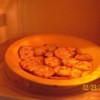 A plate of crackers in the microwave becoming crispy.