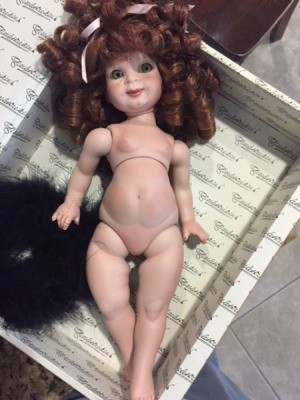 Identifying a Porcelain Doll  - undressed doll with red ringlets