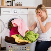 Woman unloading sour smelling laundry