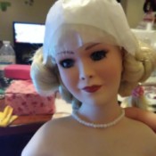 Identifying a Porcelain Doll  - blond haired doll wearing pearls and a white dress