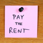 Postit note, with words "Pay the Rent" written on it.