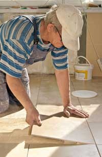 man installing ceramic tile