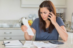 Woman concerned about her bills negotiating on the phone