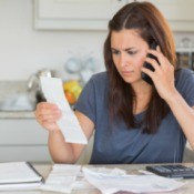 Woman concerned about her bills negotiating on the phone