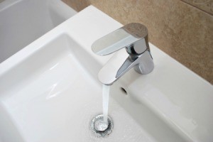 Faucet running water into Bathroom Sink