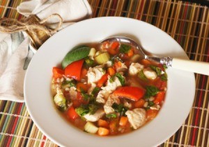 Chicken Vegetable soup in a bowl with spoon