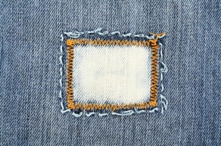 Close-up of jeans with a patch sewn on
