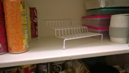 A wire shelf on a kitchen shelf.