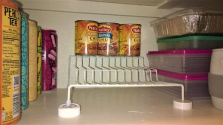 Using two pill bottle lids to support a wire shelf.