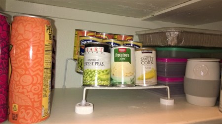Using two pill bottle lids to support a wire shelf.