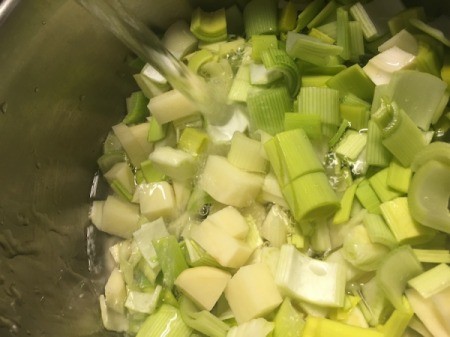 chopped leeks and potatoes in pan