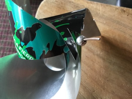 Aluminum Can Pinwheel - when all four corners are threaded place the bead on the wire