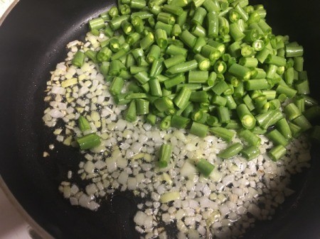 Green beans added to pan