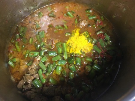 Beef and turmeric added to pan