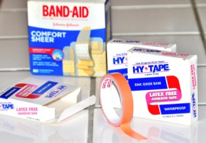 Packages of Band-Aids and Hy-Tape for covering healing wounds.