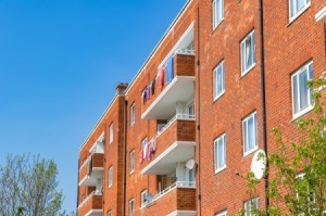 Brick apartments with laundry hanging from the balcony.