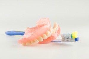 A pair of dentures and a toothbrush.