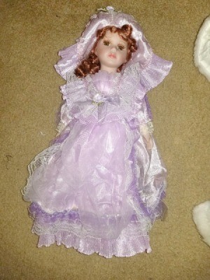 Identifying and Determining Value of Porcelain Dolls - red haired doll wearing a lavender dress