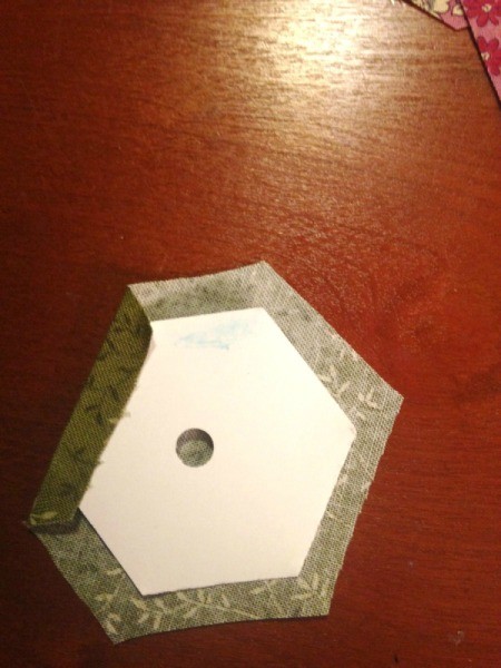 English Paper Pieced Hexagons - continue gluing and folding the fabric down in a clockwise rotation