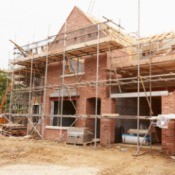 Brick house surrounded with scaffolding.