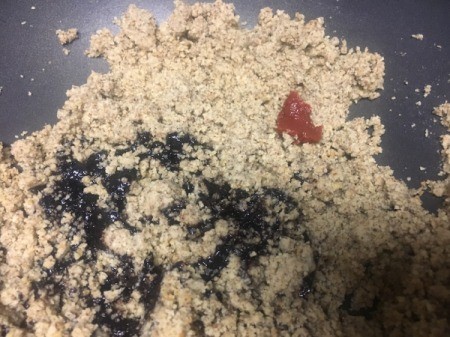 ground walnuts with molasses added to pan