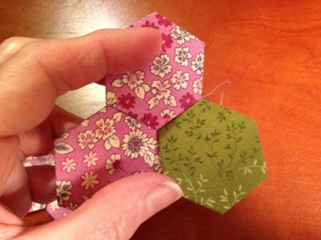 English Paper Pieced Hexagons - center stitched to one side of one hexagon