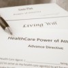 Paperwork for a healthcare power of attorney, living will and an estate plan.