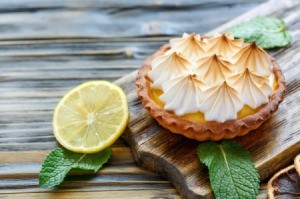 Lemon cream pie on a cutting board.