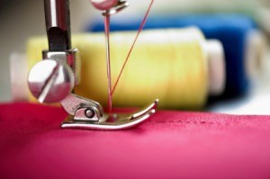 Closeup of sewing machine foot.