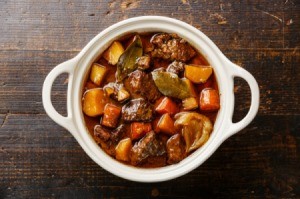 Beef Stew in white bowl on wooden table