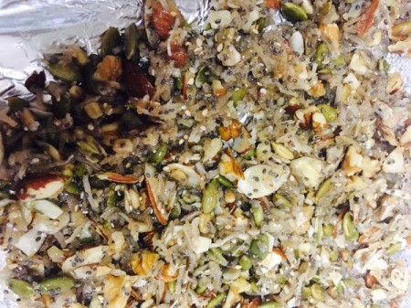 spreading granola on baking sheet