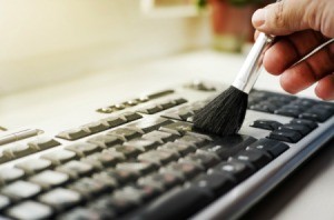 Using make-up brush to clean computer keyboard