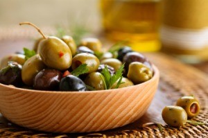 Roasted Olives in a wood bowl.