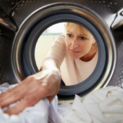 Woman reaching into a dryer.