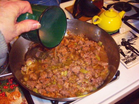 Adding broth to skillet