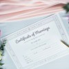 Marriage Certificate with flowers and a pen