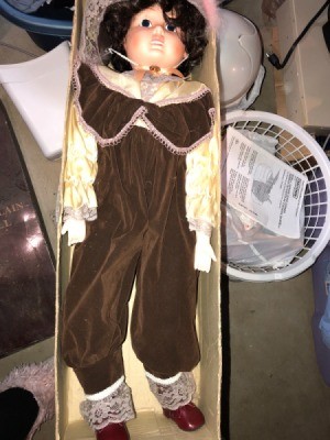 Identifying a Porcelain Doll - doll wearing a brown jumpsuit in the box